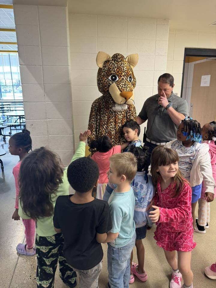 Our kindergarten students give Jerry the Jaguar some hugs!