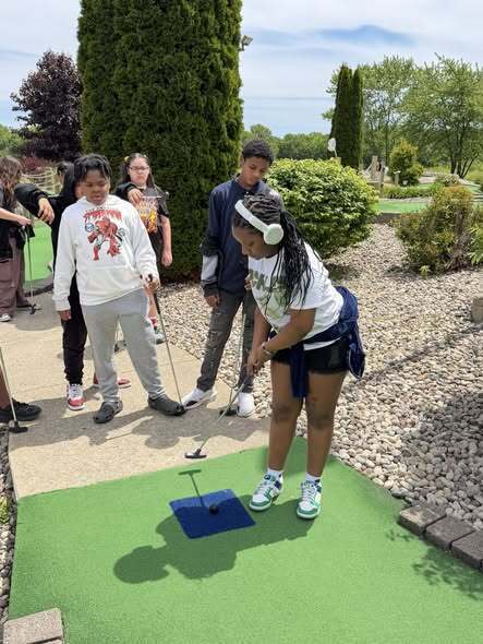 Students play mini golf