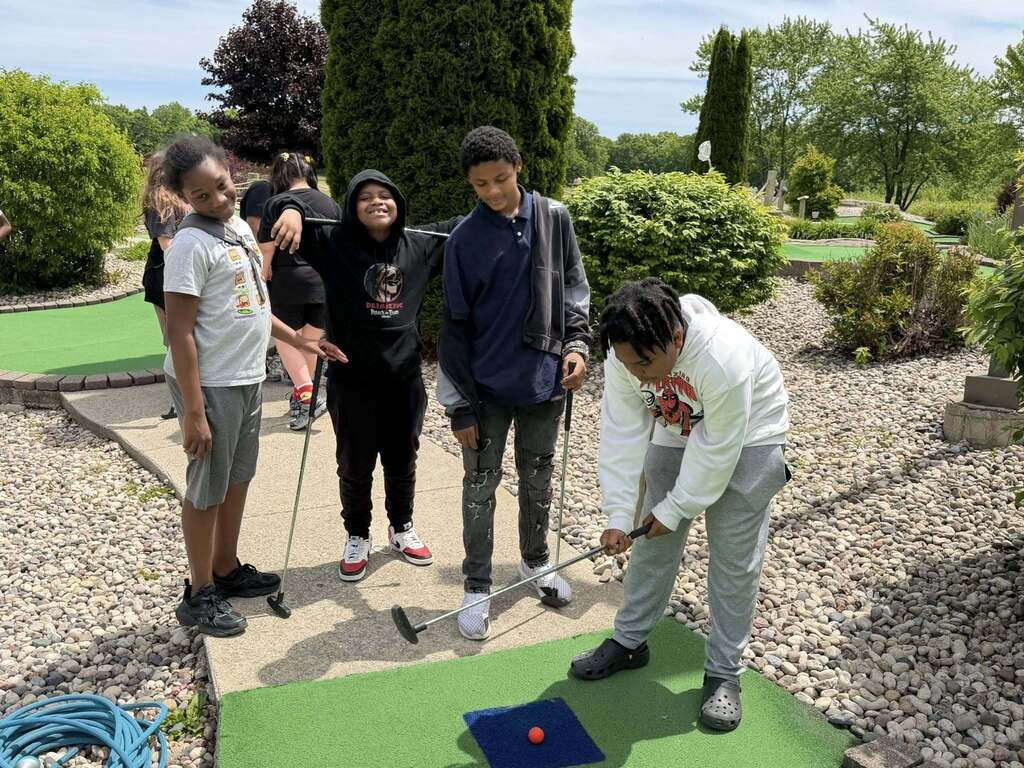 Students play mini golf