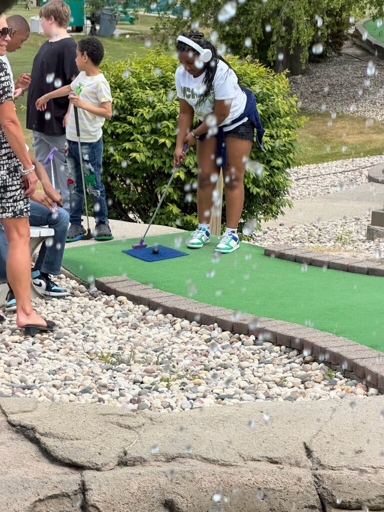 Students play mini golf