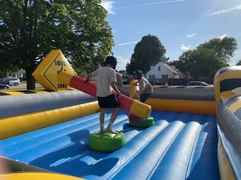 Two boys on an inflatable joust.
