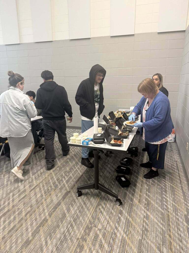 Ms. Carini handing out wingstop to our ELL students.