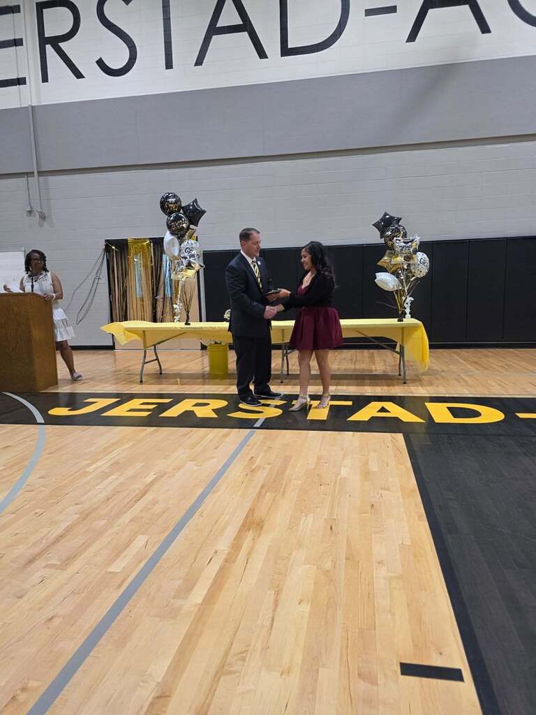 8th grade student receives an award from Mr. Paproth