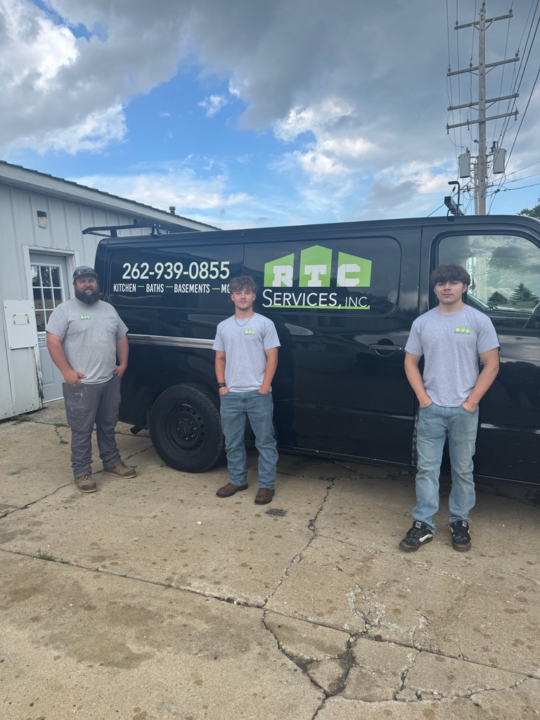 Ryan Chadek, Jace Johnson and Matteo Molini standing in front of an RTC Services van.