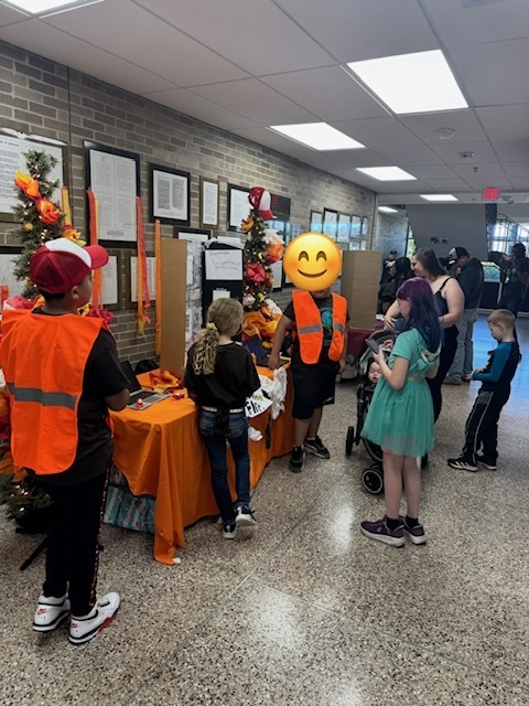 Several students looking at another student's project.