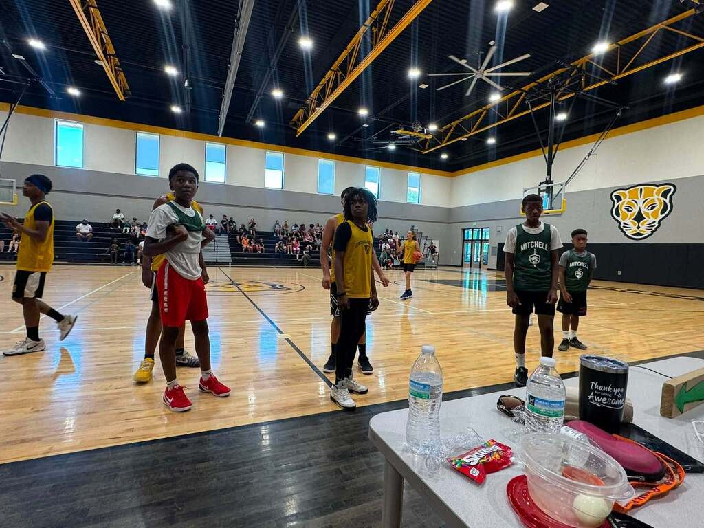 Jerstad and Mitchell basketball players on the court.