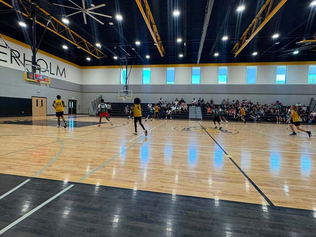 Jerstad and Mitchell basketball players on the court.