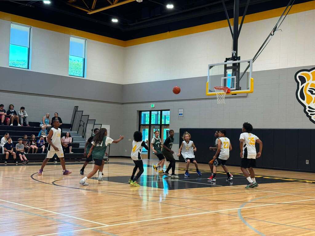 Jerstad and Mitchell basketball players on the court.