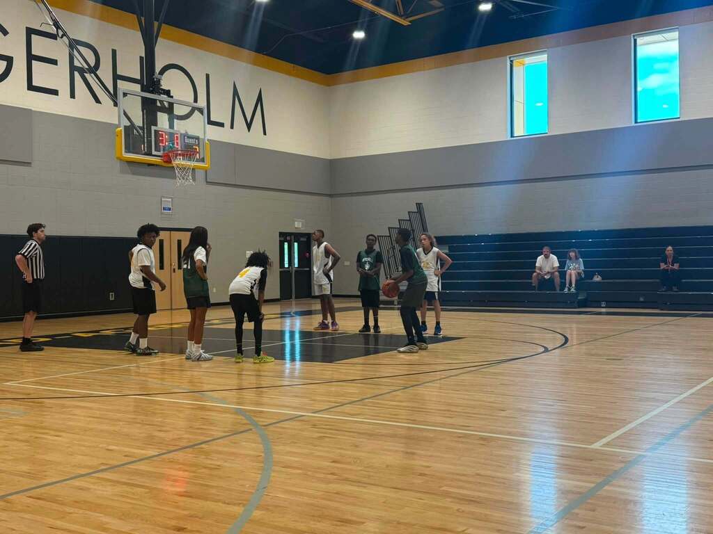 Jerstad and Mitchell basketball players on the court.