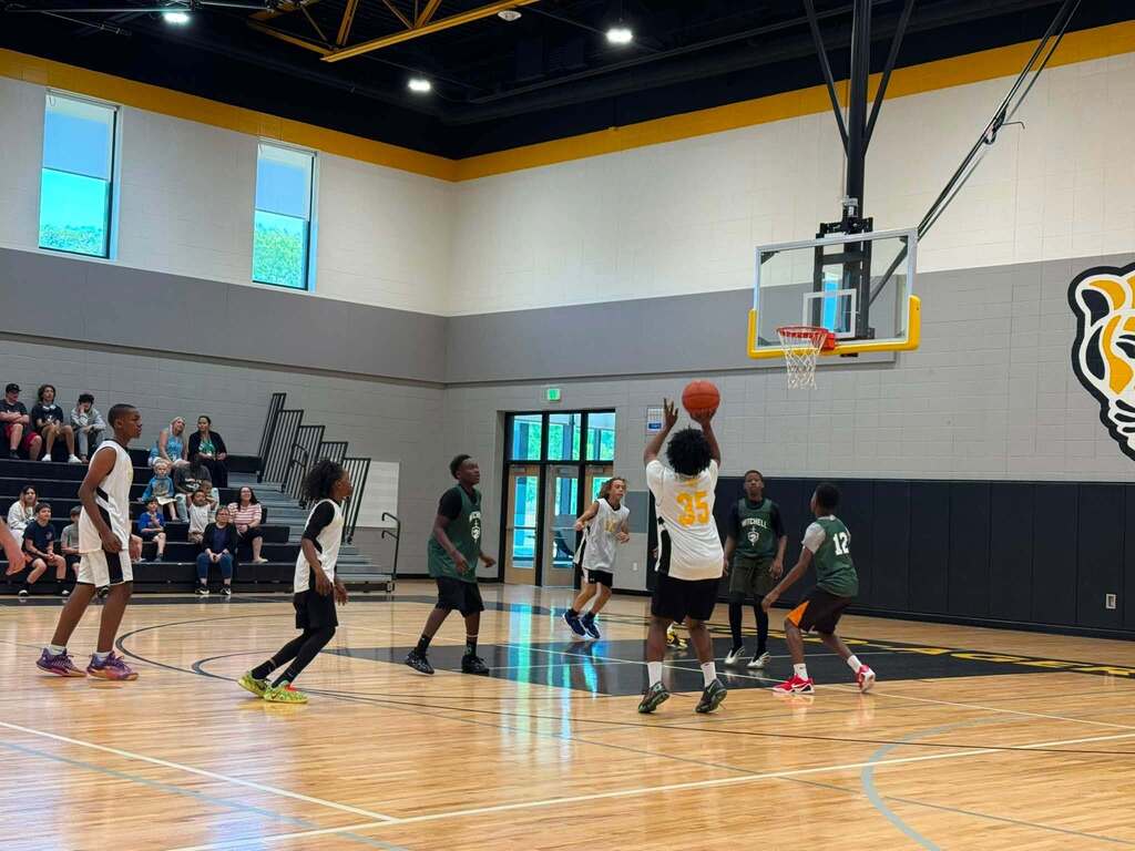 Jerstad and Mitchell basketball players on the court.