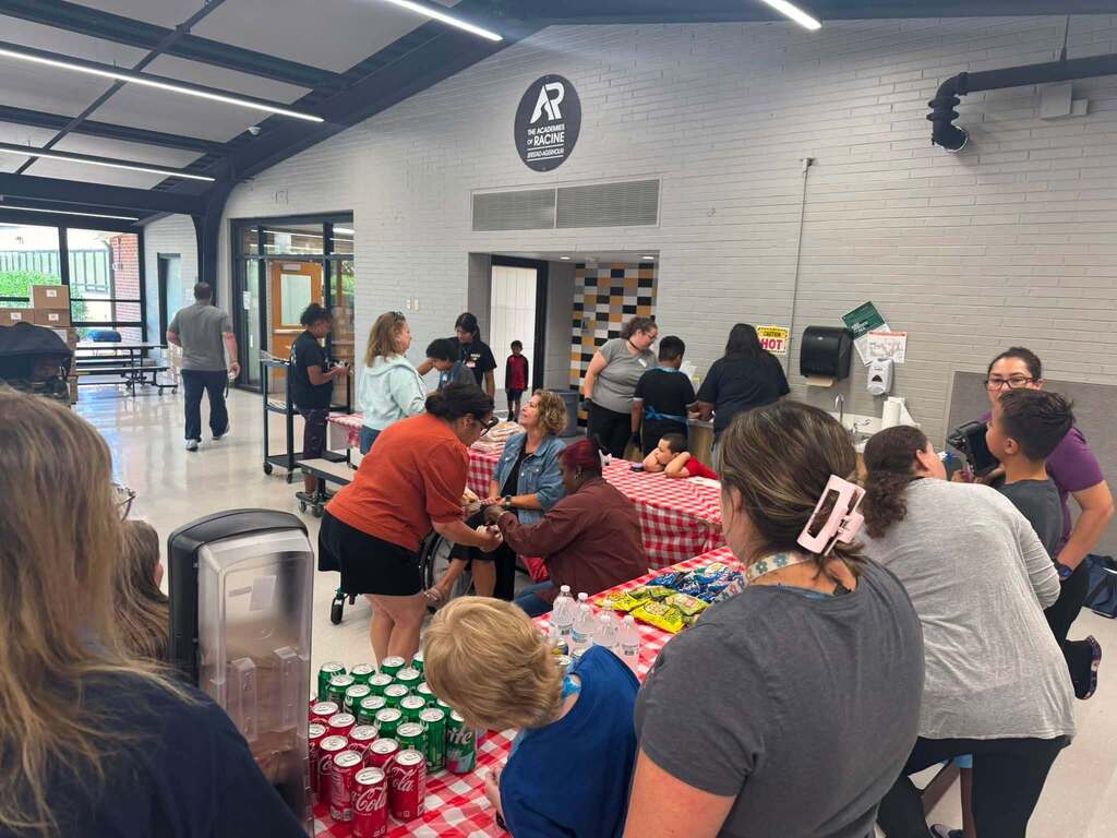 Our students serving hot dogs to staff