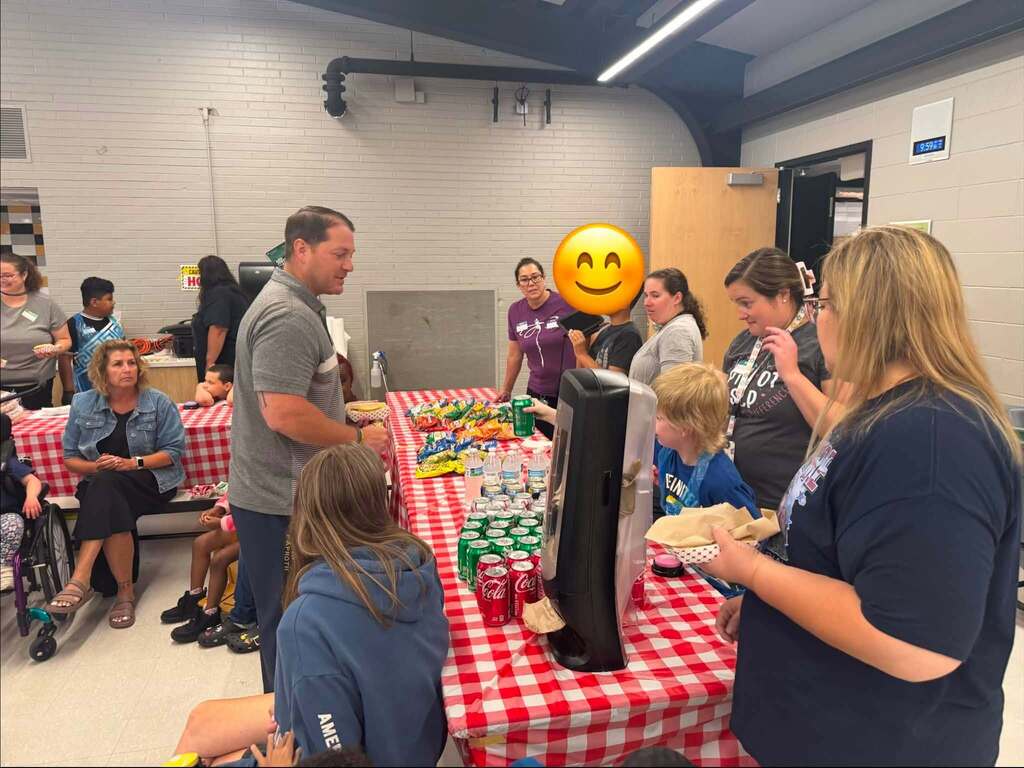 Our students serving hot dogs to staff