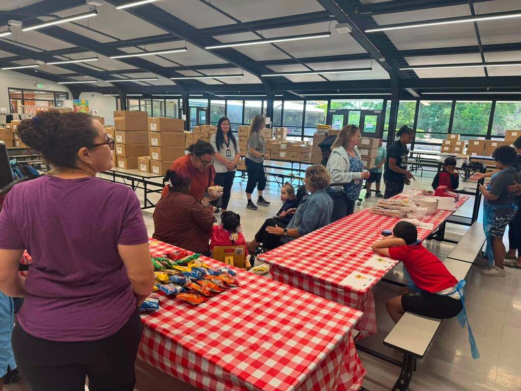 Our students serving hot dogs to staff