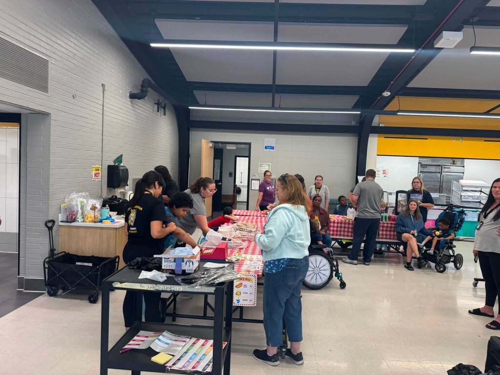 Our students serving hot dogs to staff