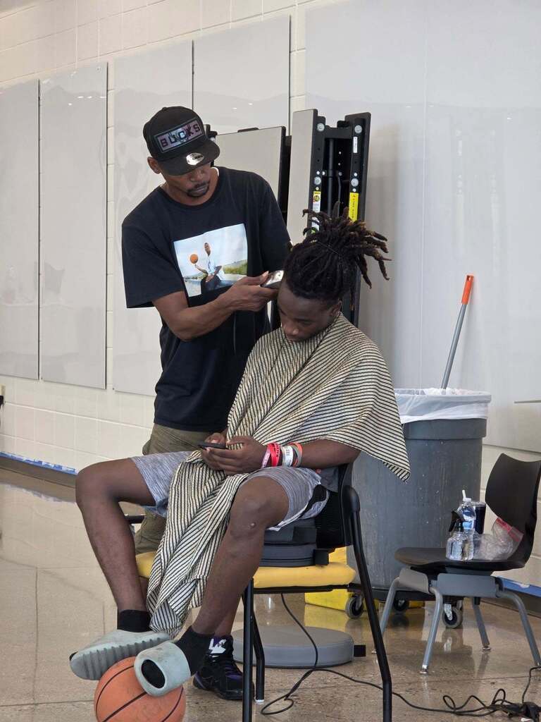 Community member gives a haircut to a Jerstad student.