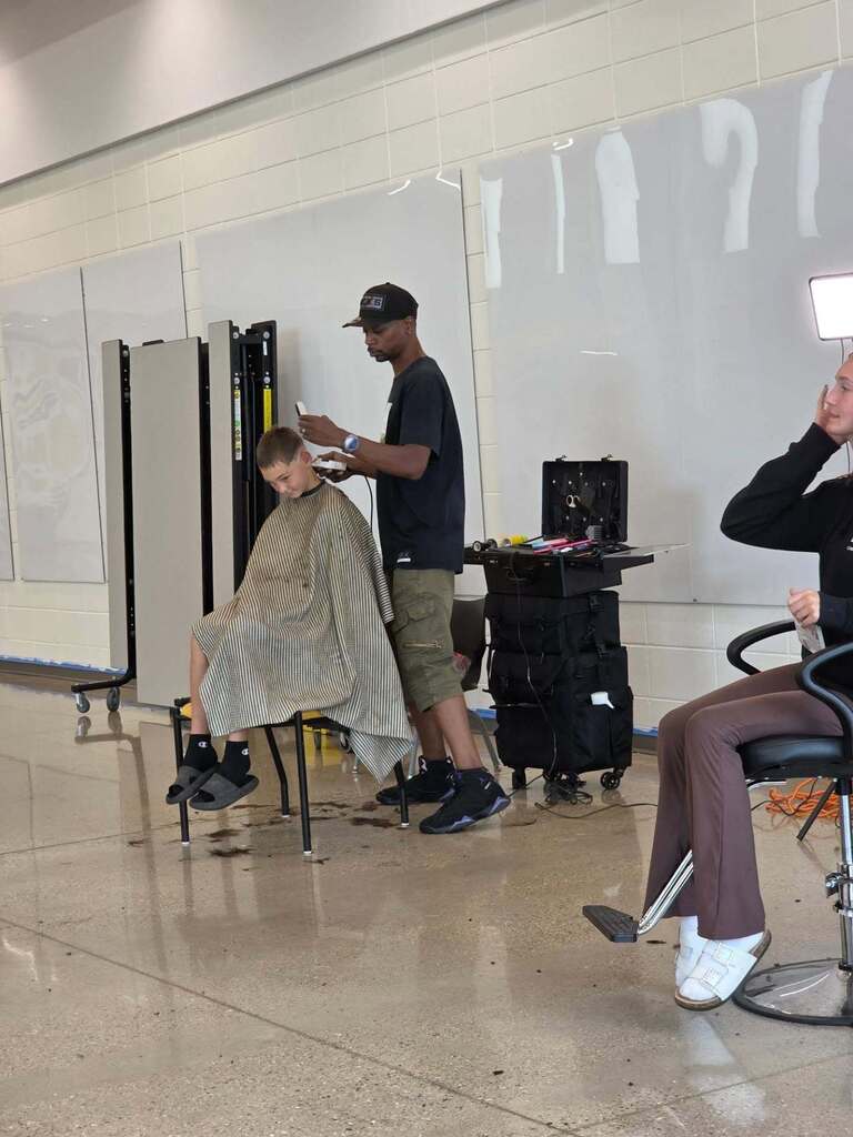 Students getting their hair cut.
