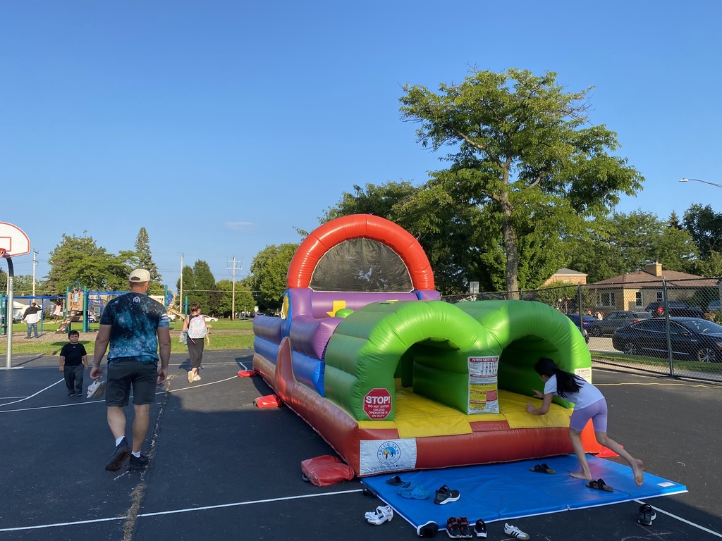 A young girl entering an inflatable obstacle course.