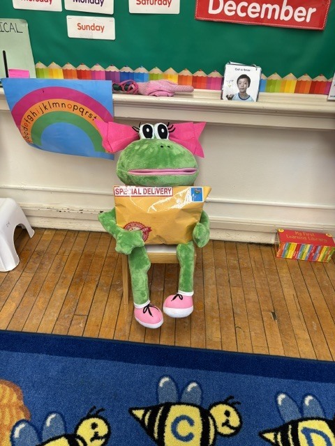 Fanny the Frog puppet holds a Special Delivery package.