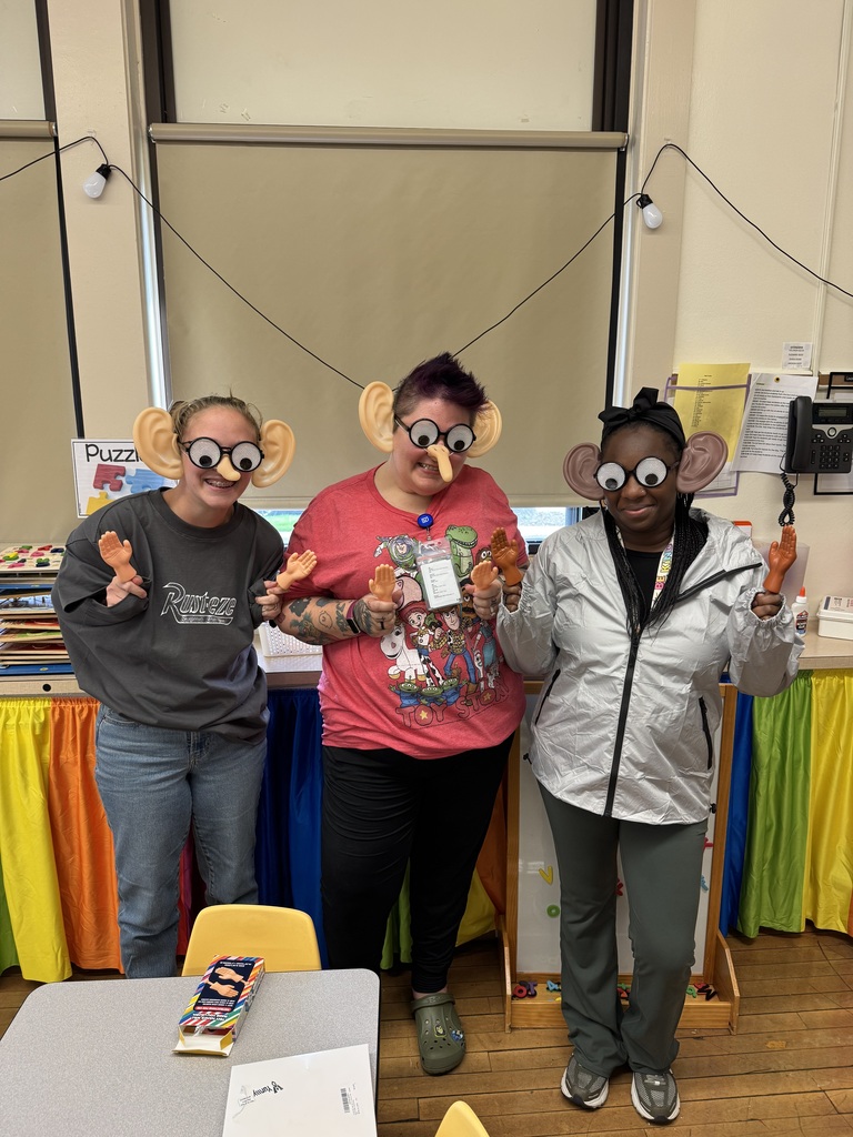 Teachers wearing exaggerated ears, noses, eyes and hands.