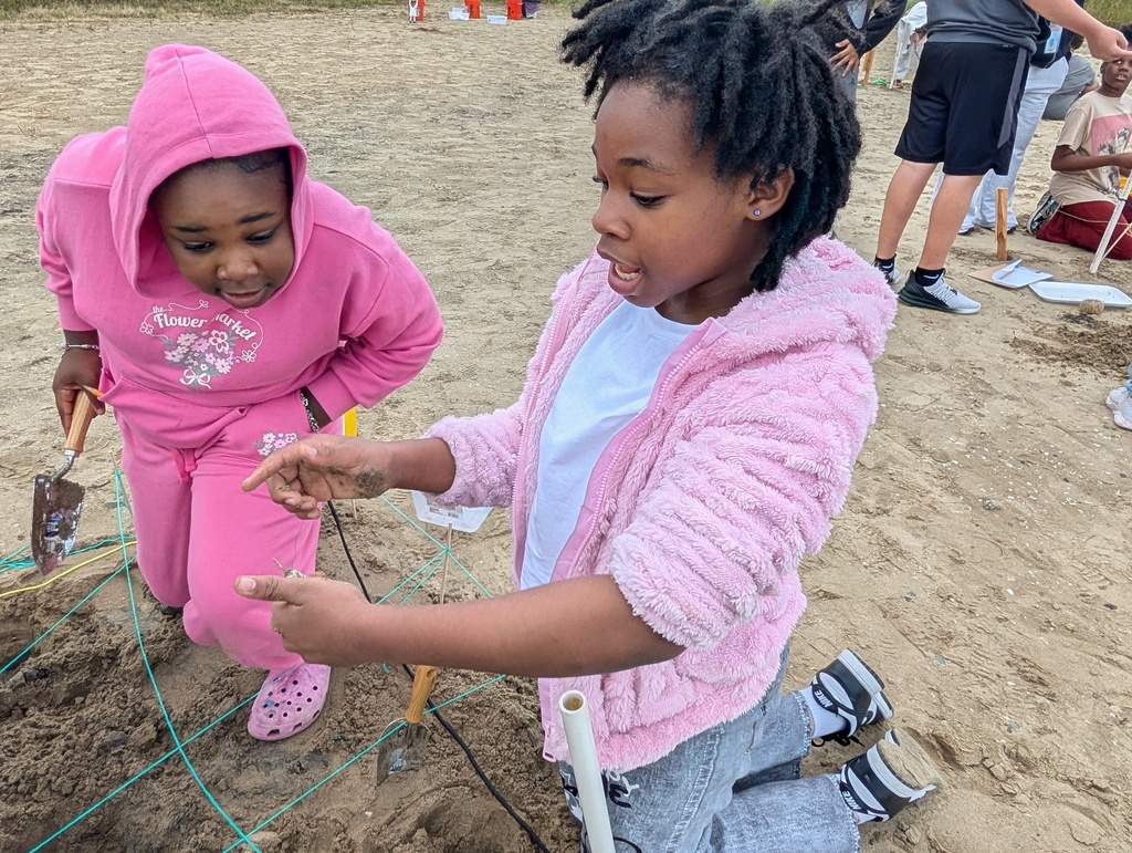 Two students who found artifiacts whild digging.