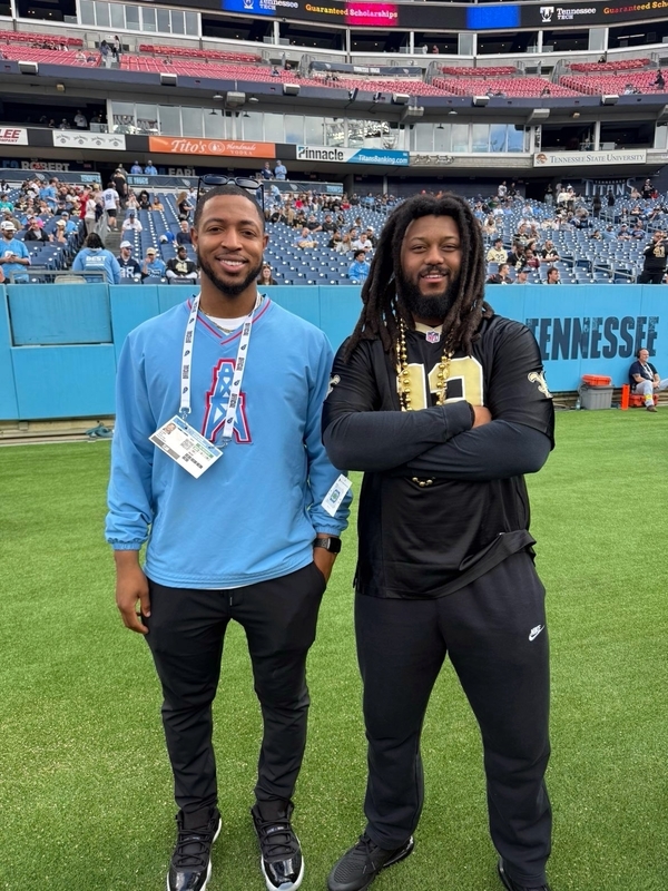 Alex Rogers on the sidelines of the Tennessee Titans Field with fellow Case alum Tyriek Thomas.