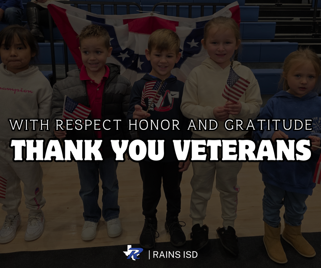 Elementary Kids holding American flags during Veterans day Celebration 