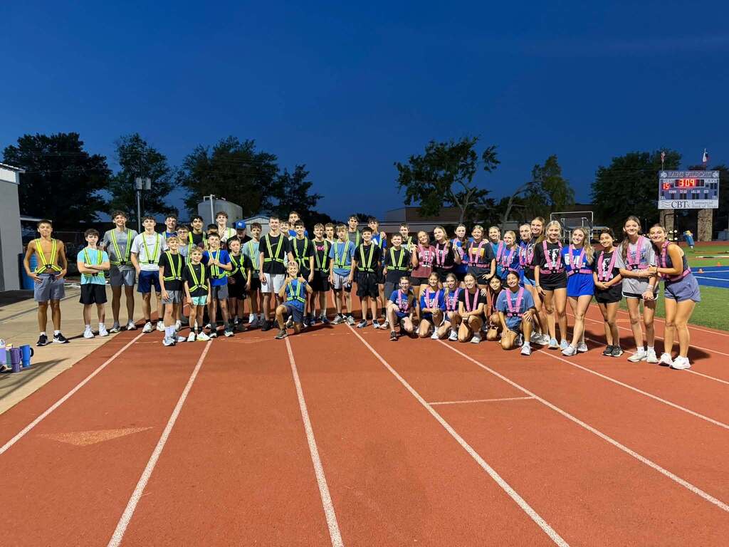 Cross Country Teams displaying their new donated safety running vests donated by the athletic booster club