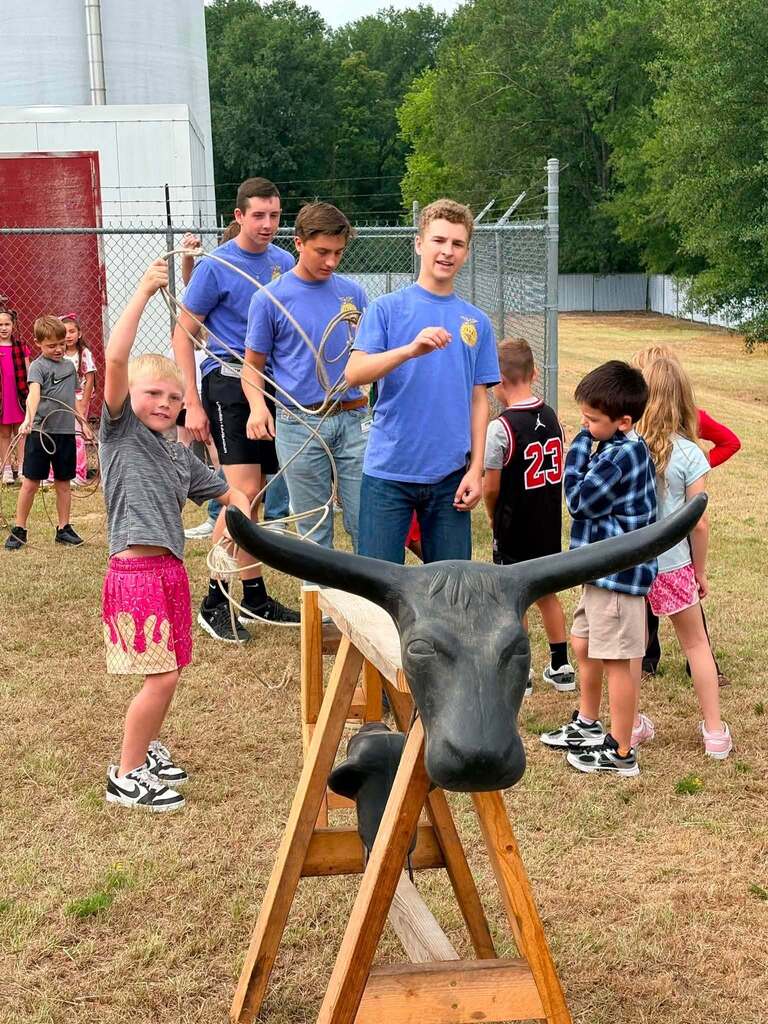 2nd Grade class roping dummy cows with the help of FFA Officers.