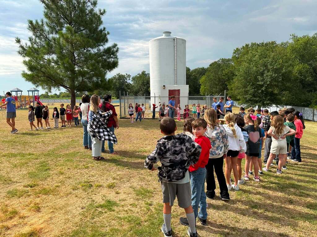 2nd Grade class roping dummy cows with the help of FFA Officers.