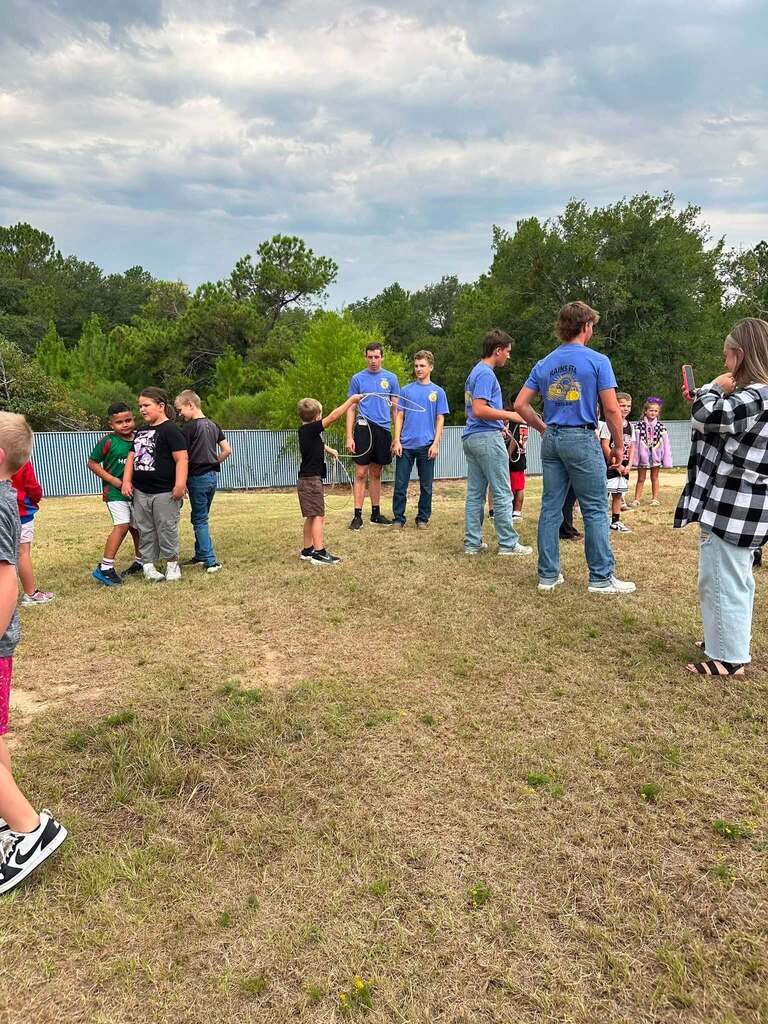 2nd Grade class roping dummy cows with the help of FFA Officers.