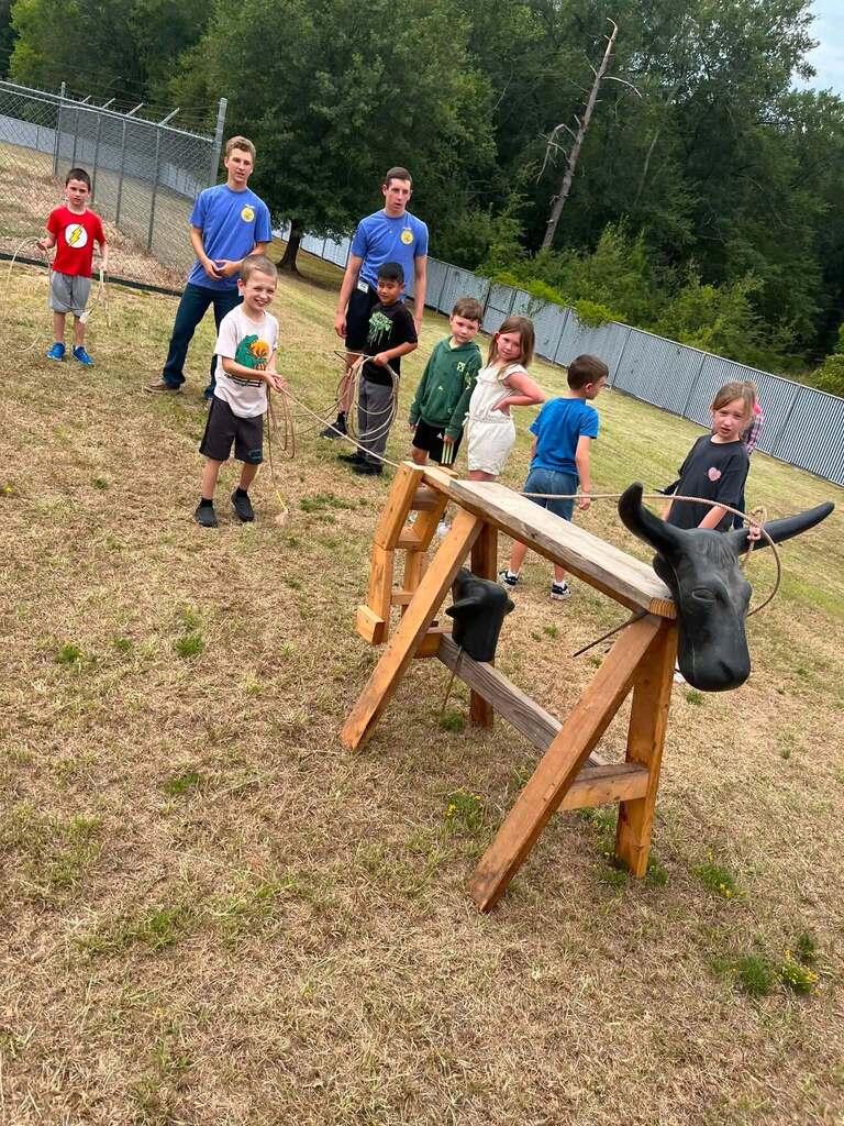 2nd Grade class roping dummy cows with the help of FFA Officers.