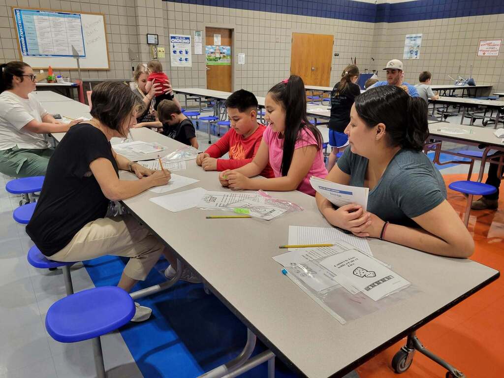 Intermediate Campus Math & Curriculum Night, Teacher helping students do a Math activity
