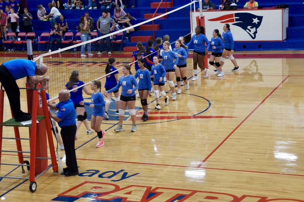 JH Volleyball team shaking hands with opponent