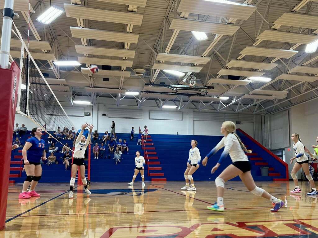 JH Volleyball team at mid play during a game