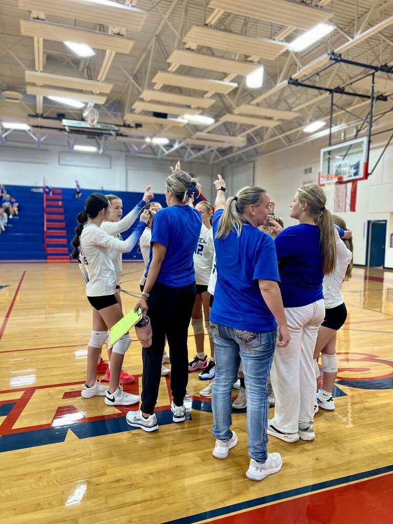 JH Volleyball huddled up to break out during a game