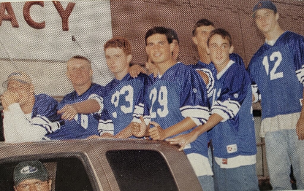 Group of boys standing in a pick up truck for the Parade
