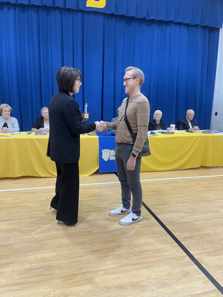 Jonathan Lance shaking Dr. Starcher's hand in acceptance of Difference Maker Award.