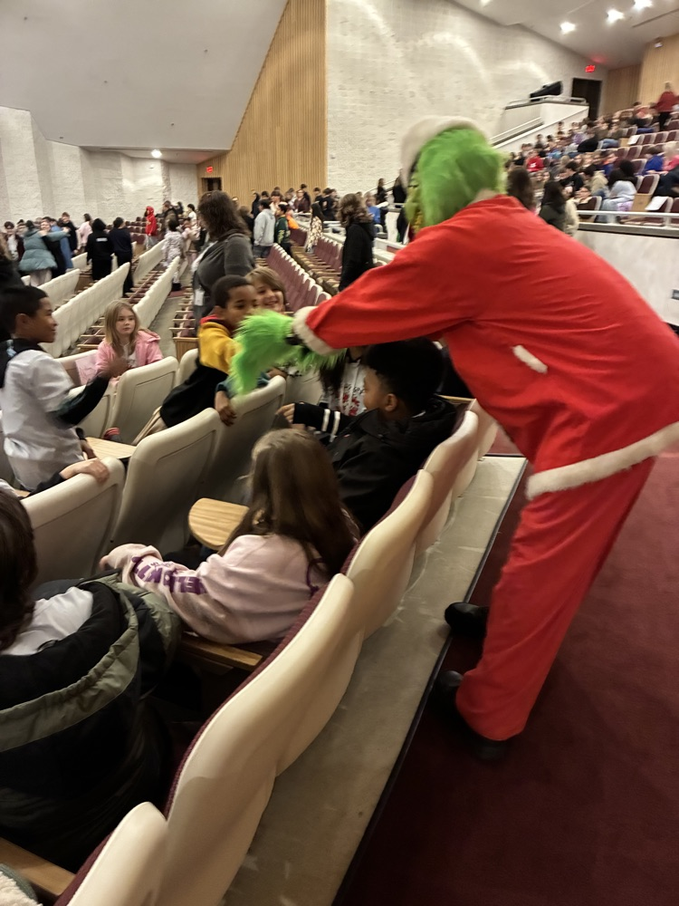 grinch shaking hands with students