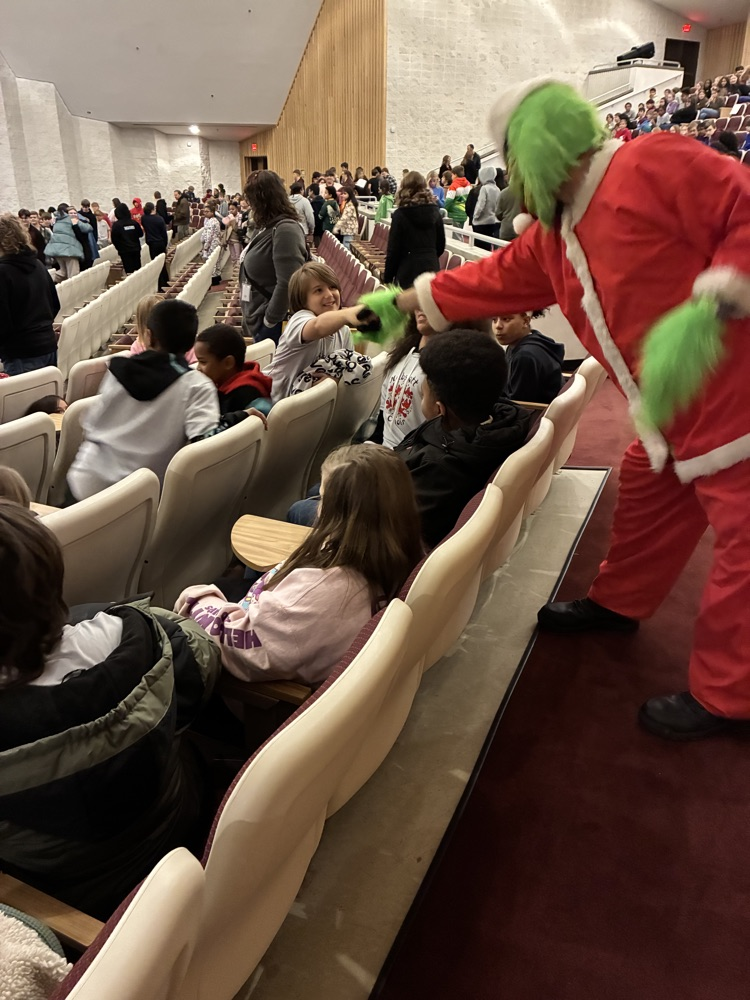 grinch shaking hands with students