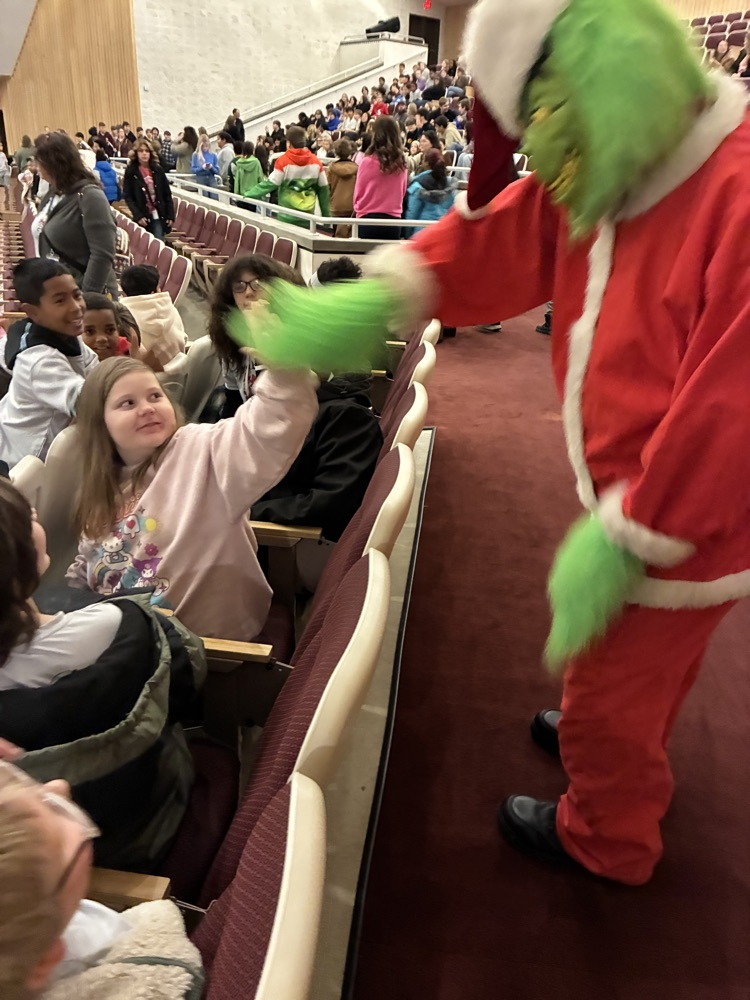 grinch waving at students 