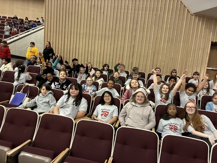 choir students sitting in seats