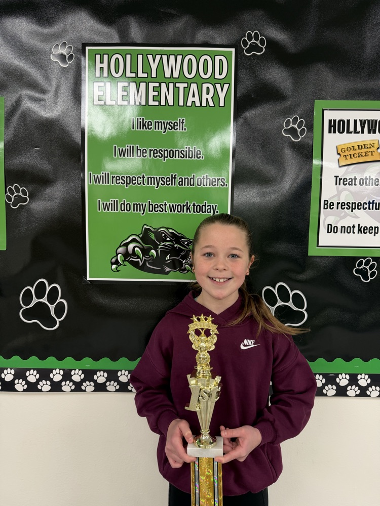 student with spelling bee trophy 