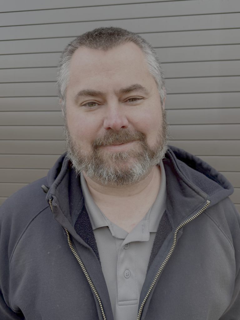 The image is a portrait of Jason Hatfield, Welding Instructor