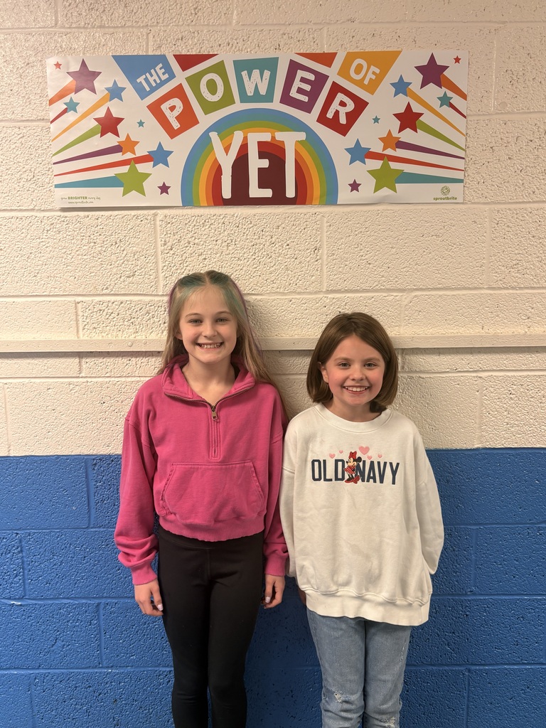 Two girls in the hallway smiling