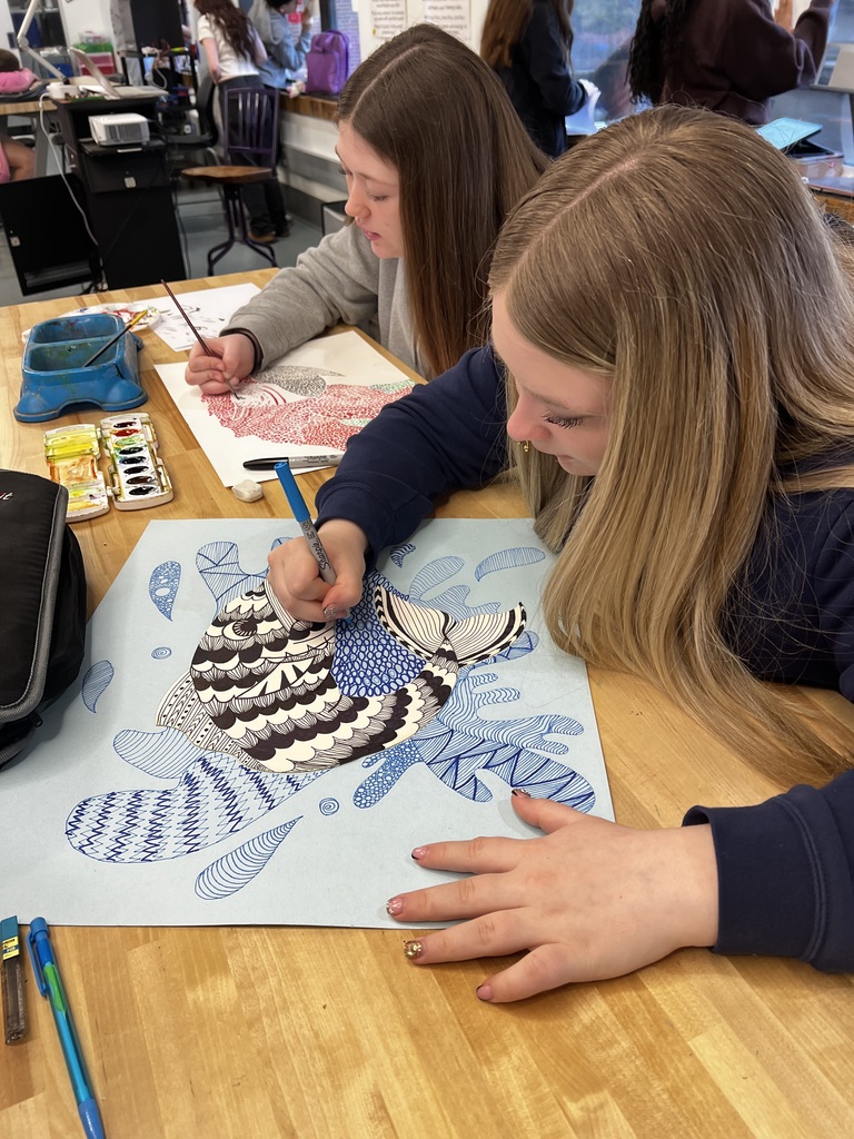 Art students add the final touches to their creations