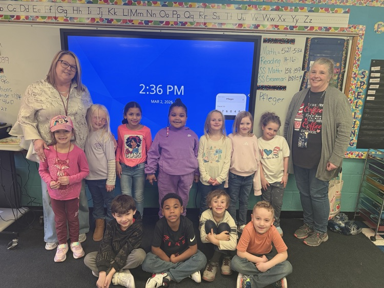 picture of students in front of board with their teachers