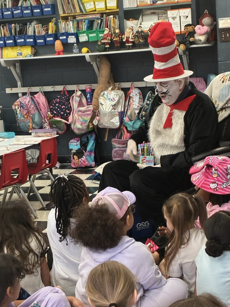 the Cat in the Hat reading to a group of students 