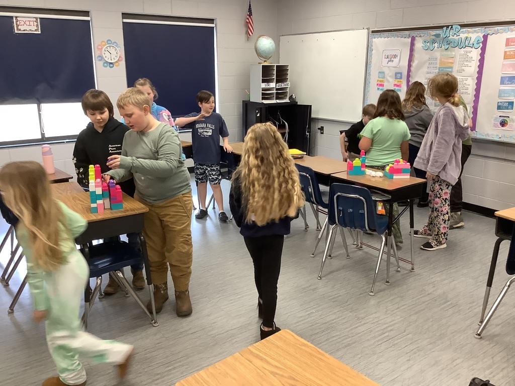 Students are building with blocks at their desks.