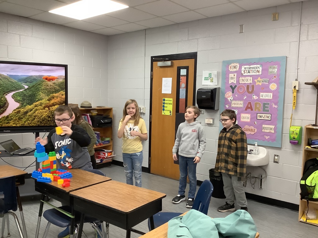 Students are building with blocks at their desks.