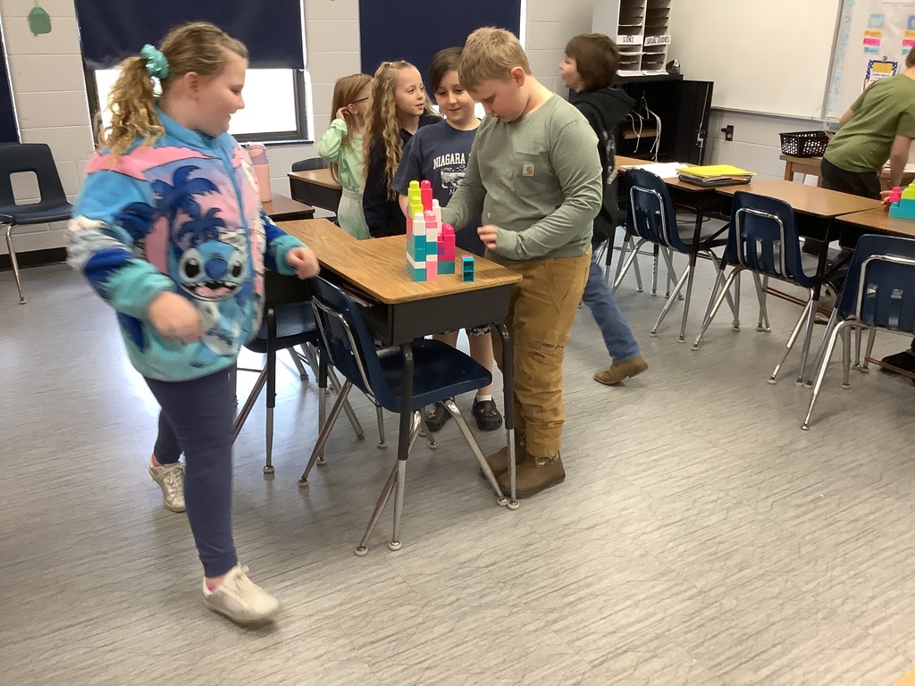 Students are building with blocks at their desks.